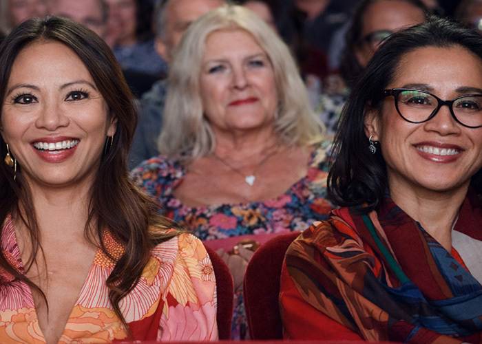 Three women smiling in the audience of the Cinequest Festival
